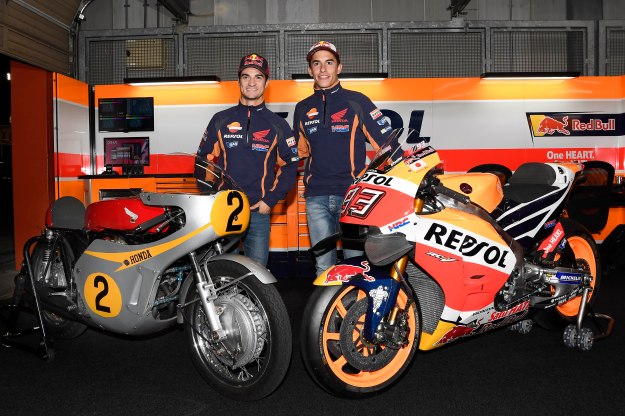 Dani Pedrosa and Marc Marquez pose with the 1966 Honda RC181 and the 2016 RC213V.